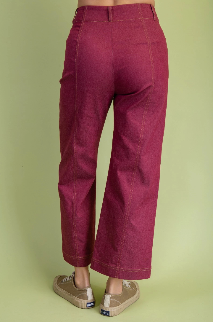 Maroon pants worn by a person on a light green background
