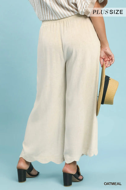 Beige wide-leg pants worn by a person on a light blue background