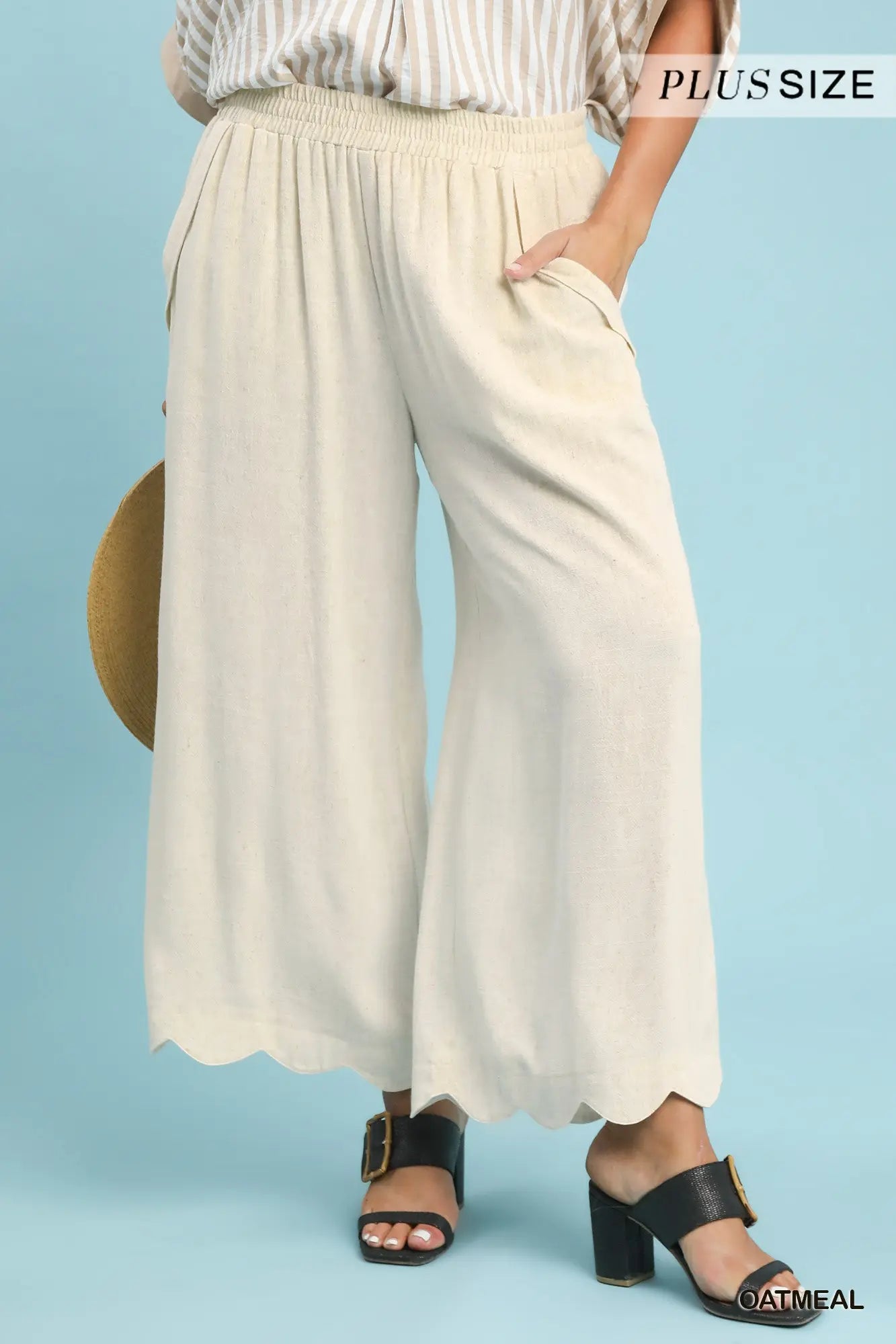 Person wearing beige wide-leg pants with a plain background