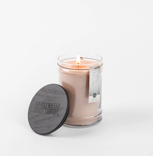 Candle with a wooden lid on a white background
