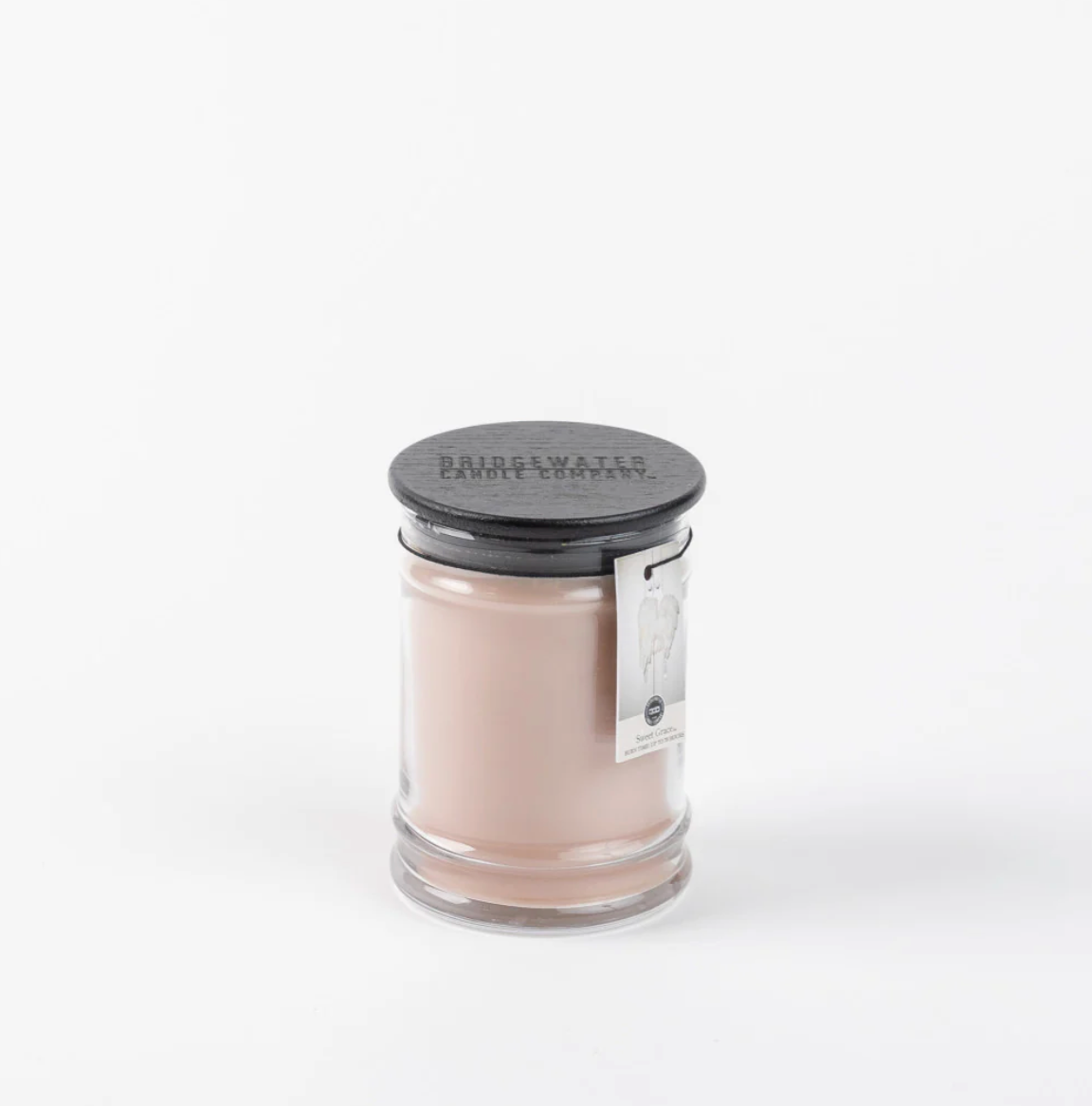 Candle in a glass jar with a black lid on a white background
