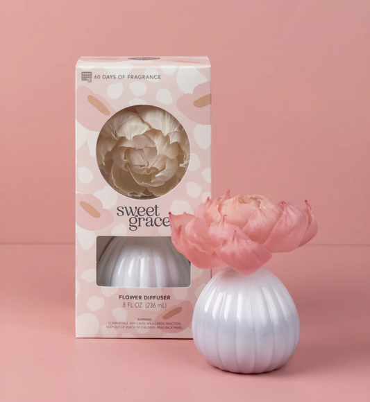 Sweet Grace flower diffuser with packaging on a pink background