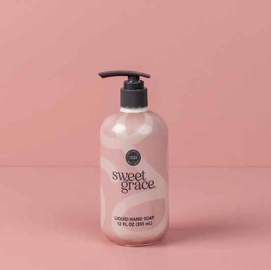 Bottle of sweet grace liquid hand soap on a pink background