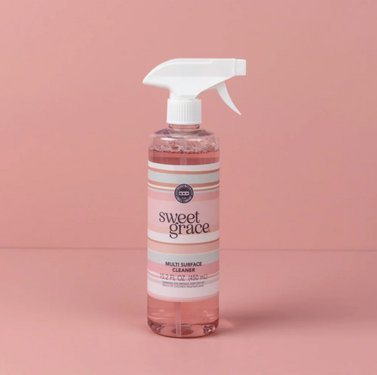 Bottle of Sweet Grace multi-surface cleaner on a pink background