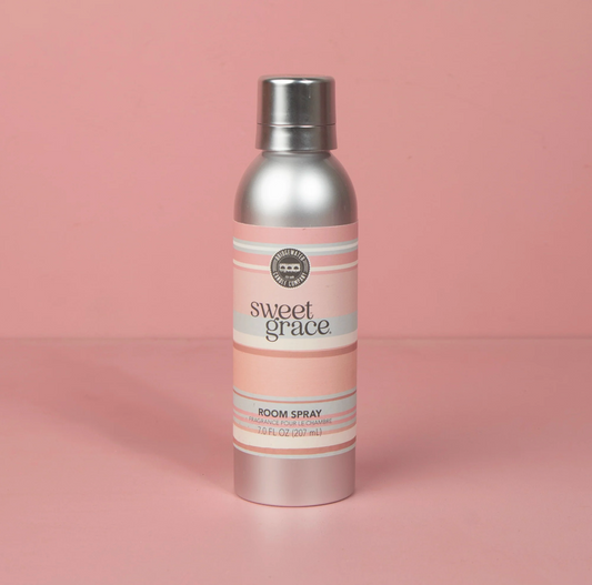 Silver and pink room spray bottle labeled 'sweet grace' on a pink background