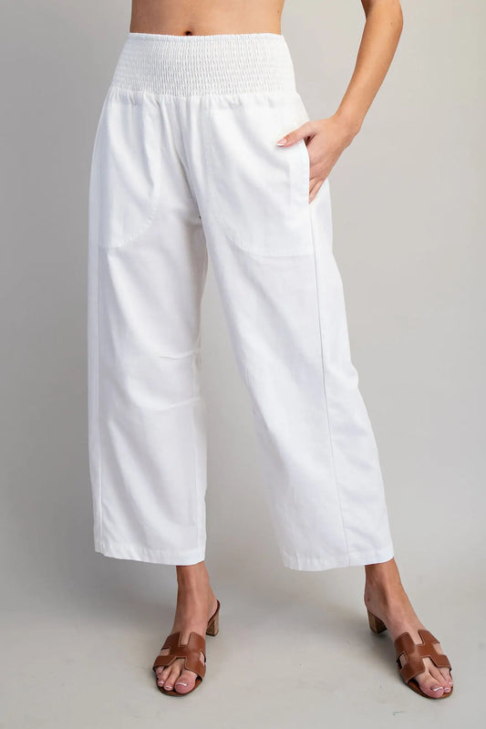 White wide-leg pants worn by a person on a plain background