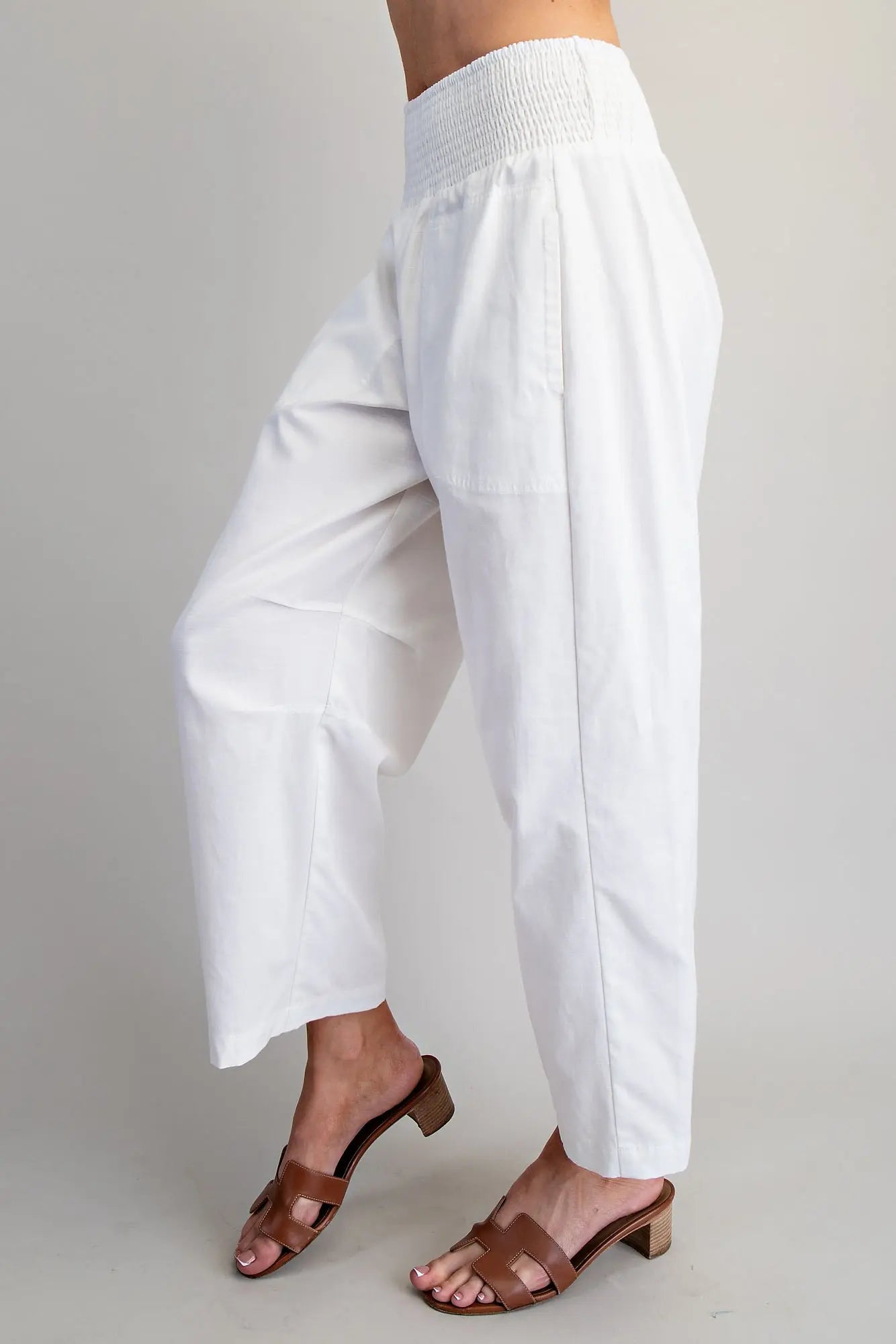 White wide-leg pants worn by a person on a plain background