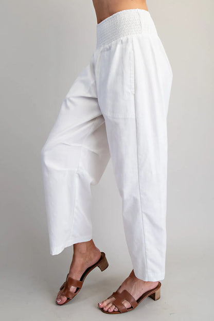 White wide-leg pants worn by a person on a plain background