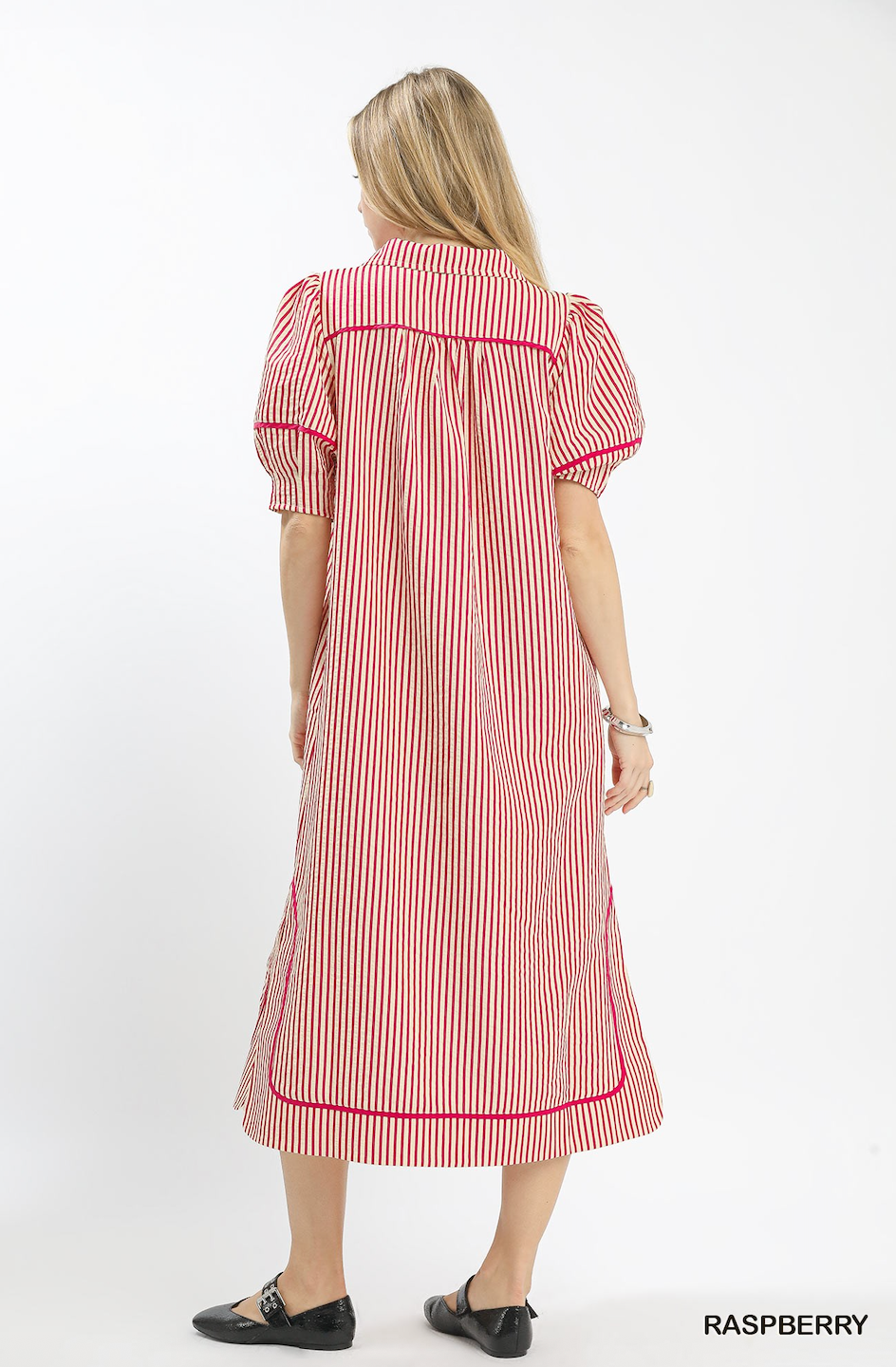 Woman wearing a red and white striped dress on a white background