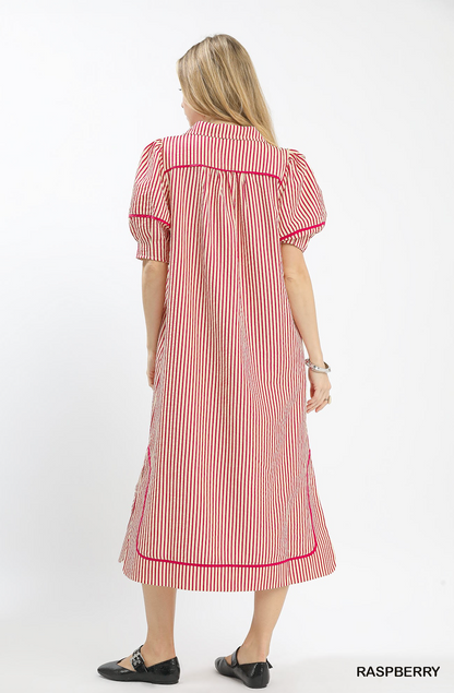 Woman wearing a red and white striped dress on a white background