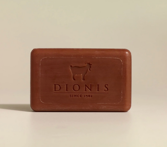 Brown bar of soap with 'Dionis' branding on a beige background