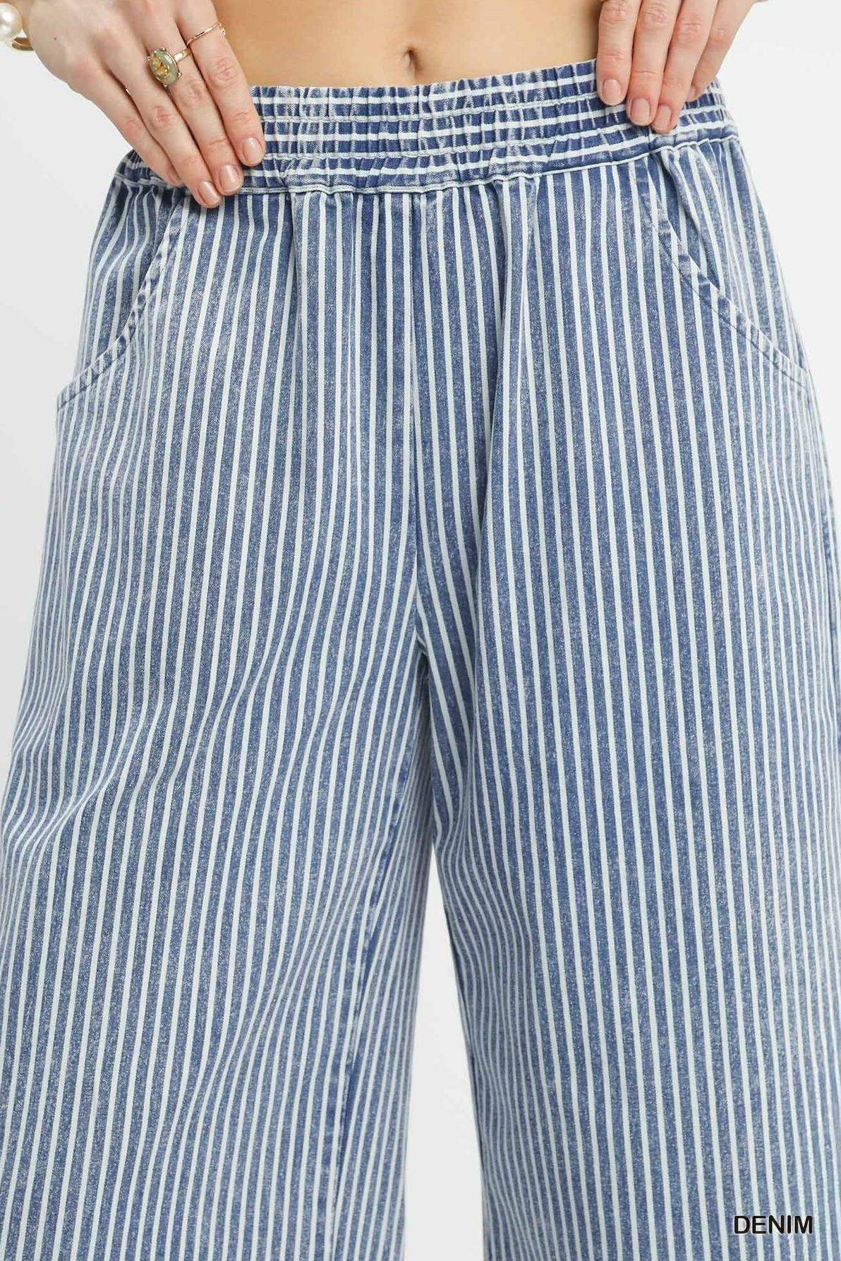 Blue and white striped pants with a close-up of the waistband.