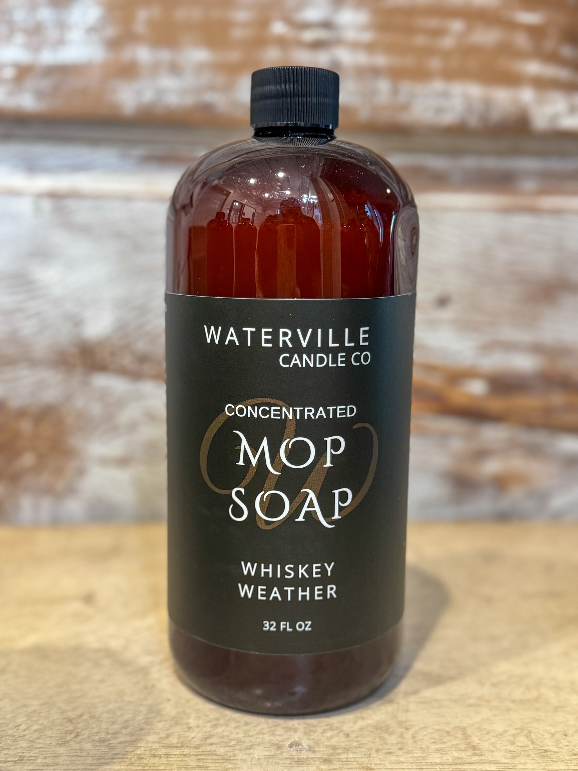 Bottle of Waterville Candle Co. Mop Soap with a wooden background